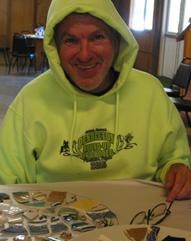 Green Leaf Industries team member in yellow-green hoodie at event table